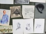 a lot of drawings on the floor of this room