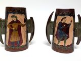 pair of art decoupholated vases with figures on them