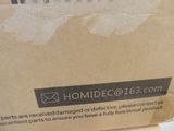 a cardboard box with a sign on it sitting on a table