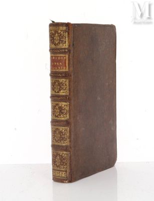 an old book sitting on top of a white table next to a white wall