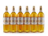 six bottles of white wine are lined up in a row
