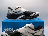 the black and white sneakers are on a blue box
