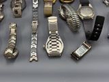 a lot of watches that are sitting on a table