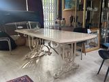 a dining room with a table and chairs and a rug