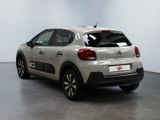 the rear end of a white citrole parked in a white room