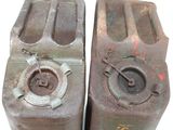 two old gas cans that are sitting next to each other