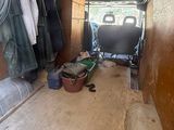 a small room with a bed and a chair in it