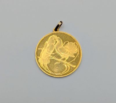 Gros plan sur une pièce d'or ornée d'un oiseau