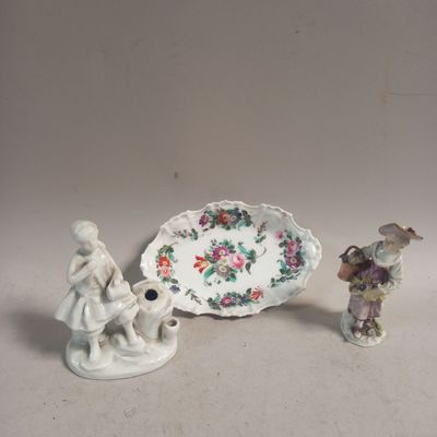 two figurines sitting next to each other on a table