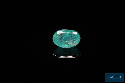 un gros plan d'une émeraude verte sur une surface noire