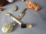 a lighter, a coin, and some other items on a table
