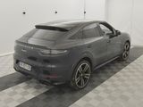 the rear end of a grey porsche cayense parked in a garage