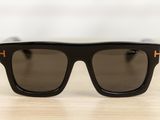 a pair of black sunglasses sitting on top of a wooden table