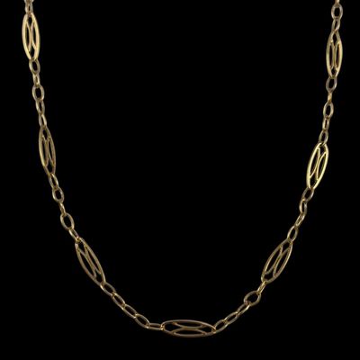 a gold chain necklace with a long link on a black background