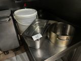 a pot and a pan on a table in a kitchen
