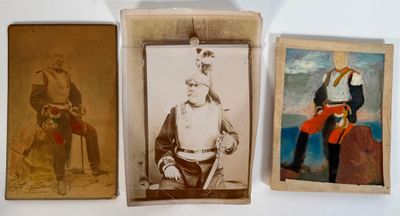 three old photos of men in military clothing are displayed on a wall