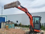 a small excavator that is sitting in the dirt
