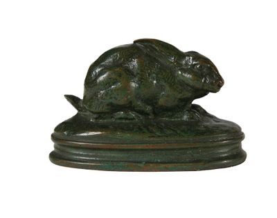 une sculpture en bronze représentant un lapin sur un socle