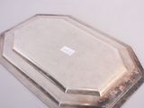 a silver tray with a silver lid on a white table