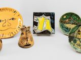 several pieces of pottery sitting on top of a table next to each other