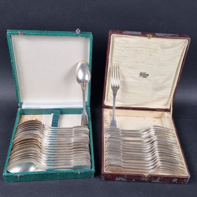 a lot of silver spoons and spoons in a case