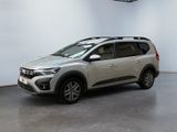 a silver suv parked in a large room with a white wall