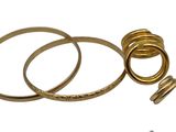 three gold rings and two silver rings on a white background