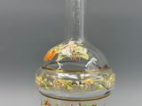 un vase en verre avec un oiseau sur une table