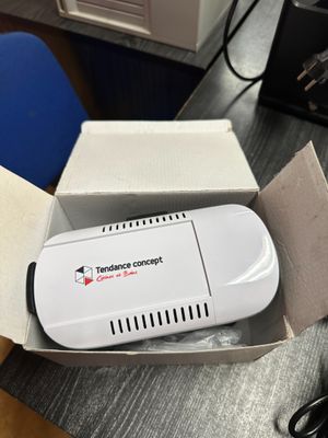 a white device in a box sitting on a table
