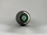 a silver ball with a green logo on it