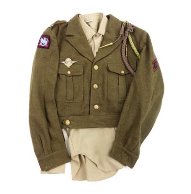 an army uniform worn by a soldier on display on a white background