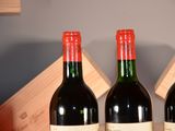 three bottles of wine sitting on a table next to each other