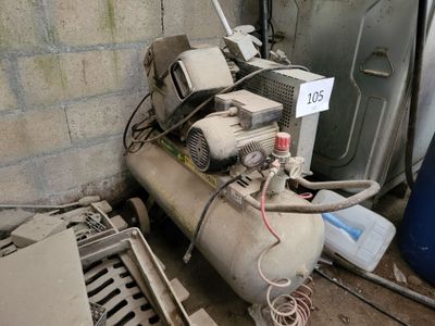 a small air compressor sitting on the ground next to other items