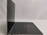 an open laptop computer sitting on top of a white surface