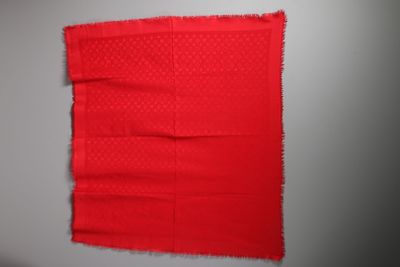 a close up of a piece of red fabric on a wall