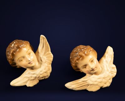 two figurines of angels on a blue background