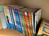 many children ' s books on a shelf in a bookcase