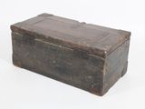 an old wooden box that is sitting on a white surface
