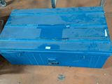 a blue box sitting on the floor next to a chair