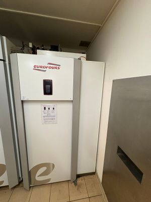 two refrigerators that are in a room with tile flooring