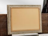 a picture frame sitting on top of a table next to other items