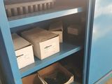 a blue cabinet that has a bunch of boxes on it