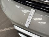 a close up of a car with a ruler on the front of it