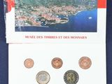 an image of a booklet with a picture of a city and a lot of coins