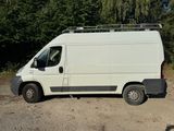 a white van that is parked in the dirt