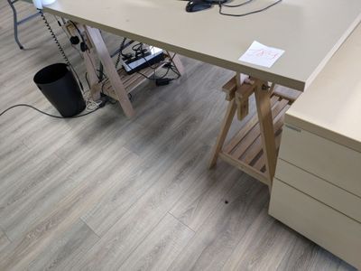 a desk with a laptop on top of it in a room