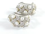 pair of pearl and diamond earrings on a white background