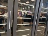 three glass doors that are open in a store