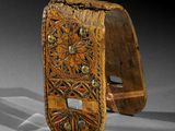 pair of carved wooden cuff bracelets with floral designs on them