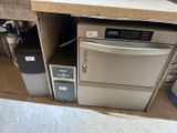 a silver dishwasher and a refrigerator in a room
